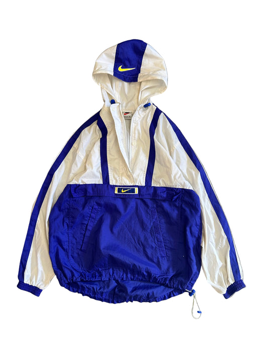 vintage Nike windbreaker from the 1990s, featuring a blue and white colorblock design and yellow embroidered logos Medium