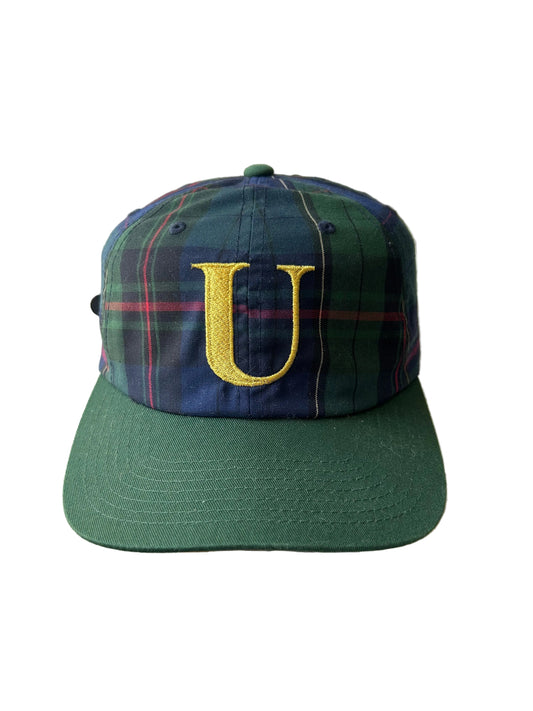 green and plaid Undefeated cap with a yellow embroidered "U" logo. Adjustable