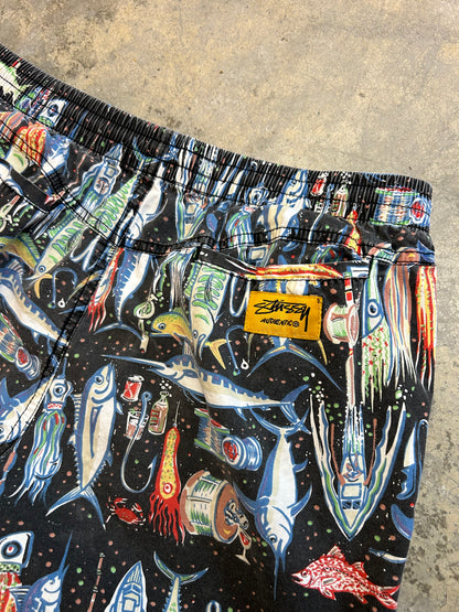 Stüssy beach shorts featuring an all-over fishing-themed graphic print size 34