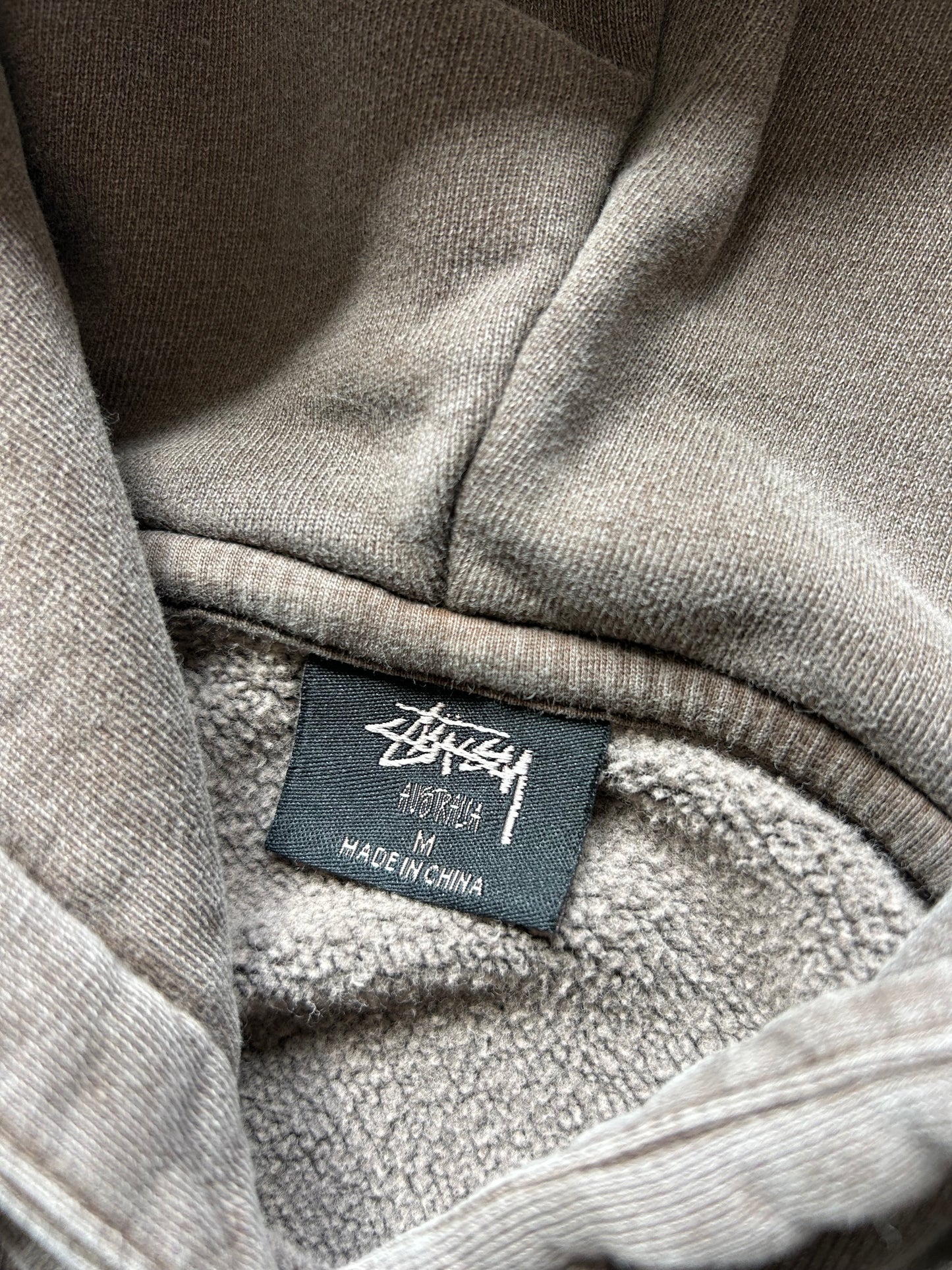 Stüssy 8 Ball Pigment Dyed Hoodie in a brown/taupe color, made from heavy cotton fleece
