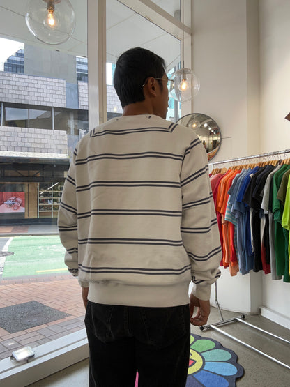 Vintage Polo Ralph Lauren striped crew neck sweater features a white base with navy horizontal stripes and an embroidered crest on the chest.