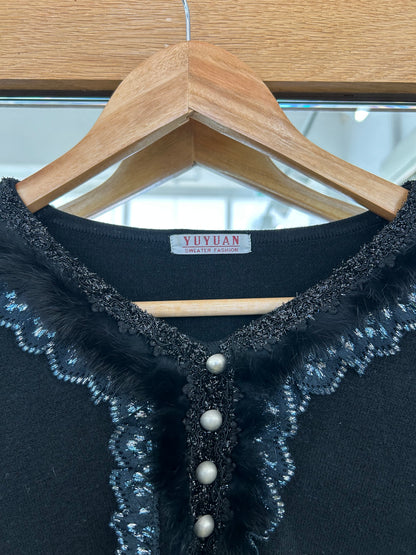 Yuyuan black long-sleeve sweater features a V-neckline adorned with delicate lace trim and pearl-like button details