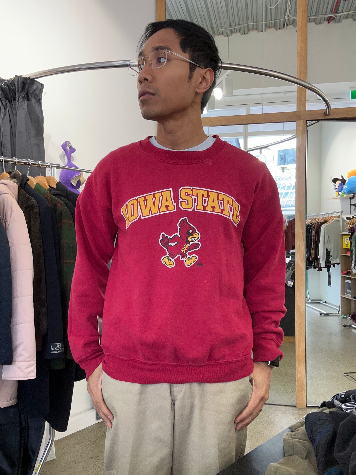 Vintage red crewneck sweatshirt features an Iowa State University graphic with the mascot Cy Medium