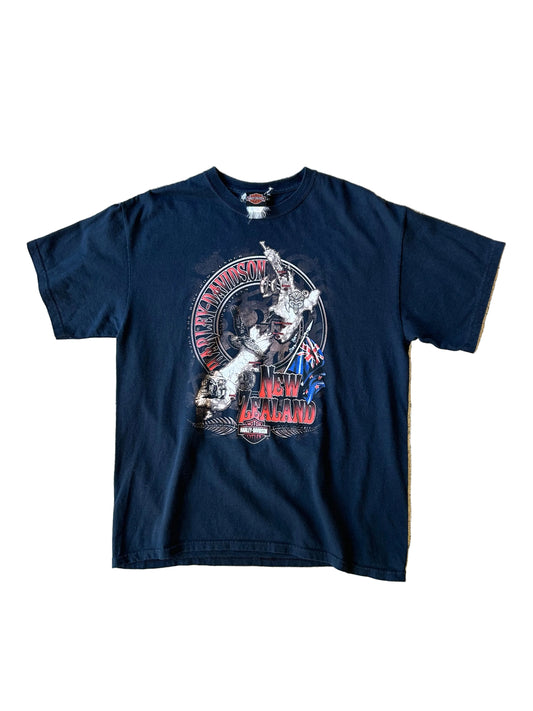 vintage black Harley-Davidson New Zealand graphic T-shirt featuring a Māori tiki or tribal design alongside the New Zealand flag.Wellington 1998