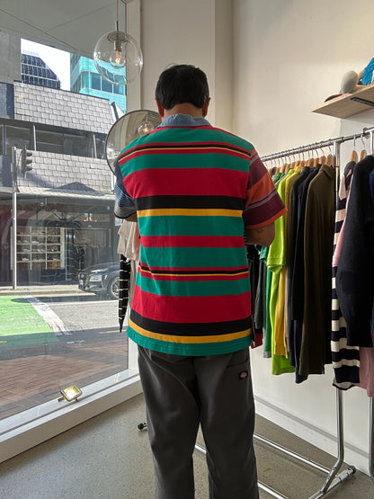 Canterbury of New Zealand short-sleeve rugby jersey features a distinctive multicolored striped design with a large logo