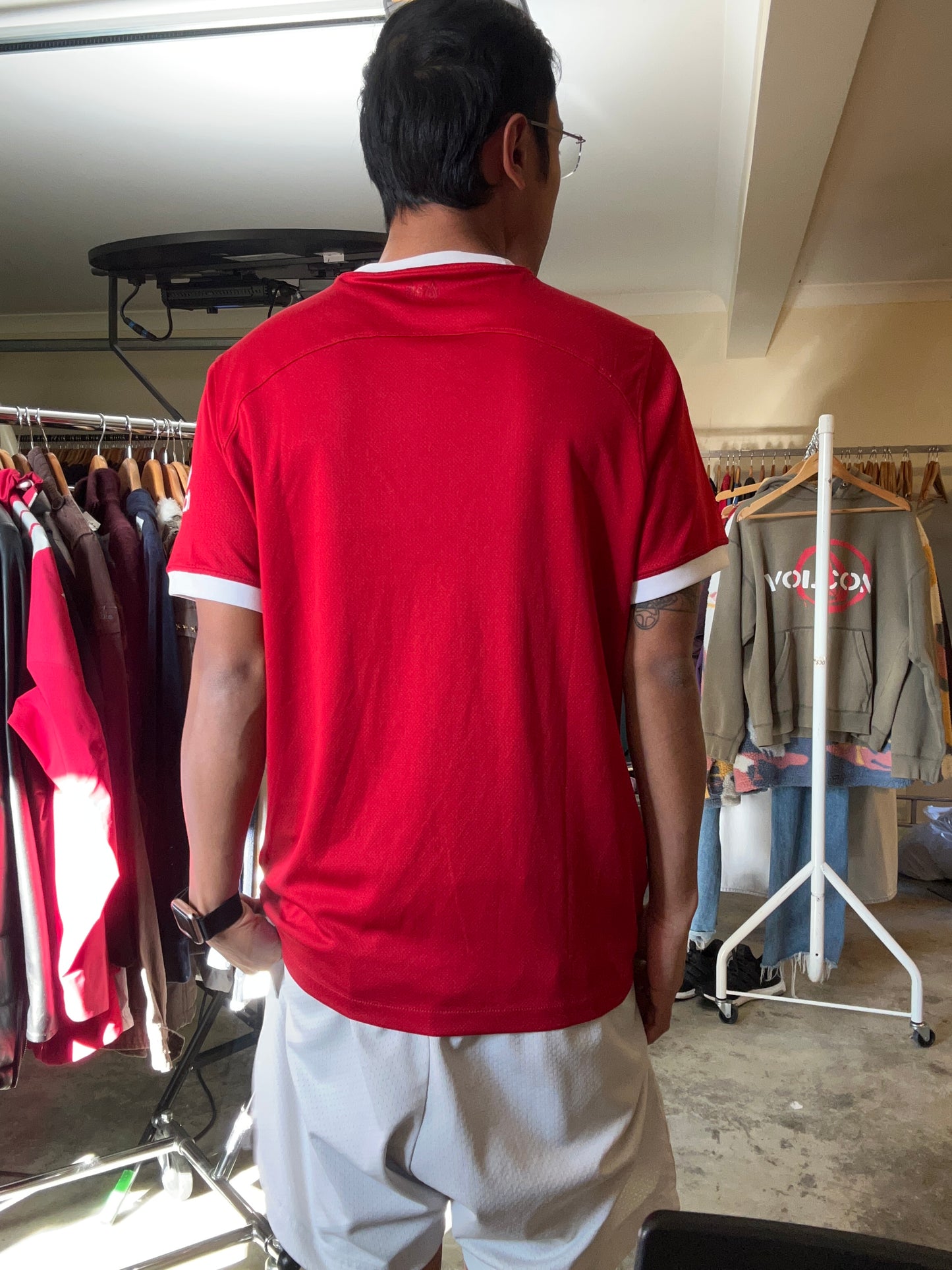 Nike Liverpool FC 2023/24 Home Jersey, featuring a classic red design with prominent white collar and sleeve cuffs. Medium