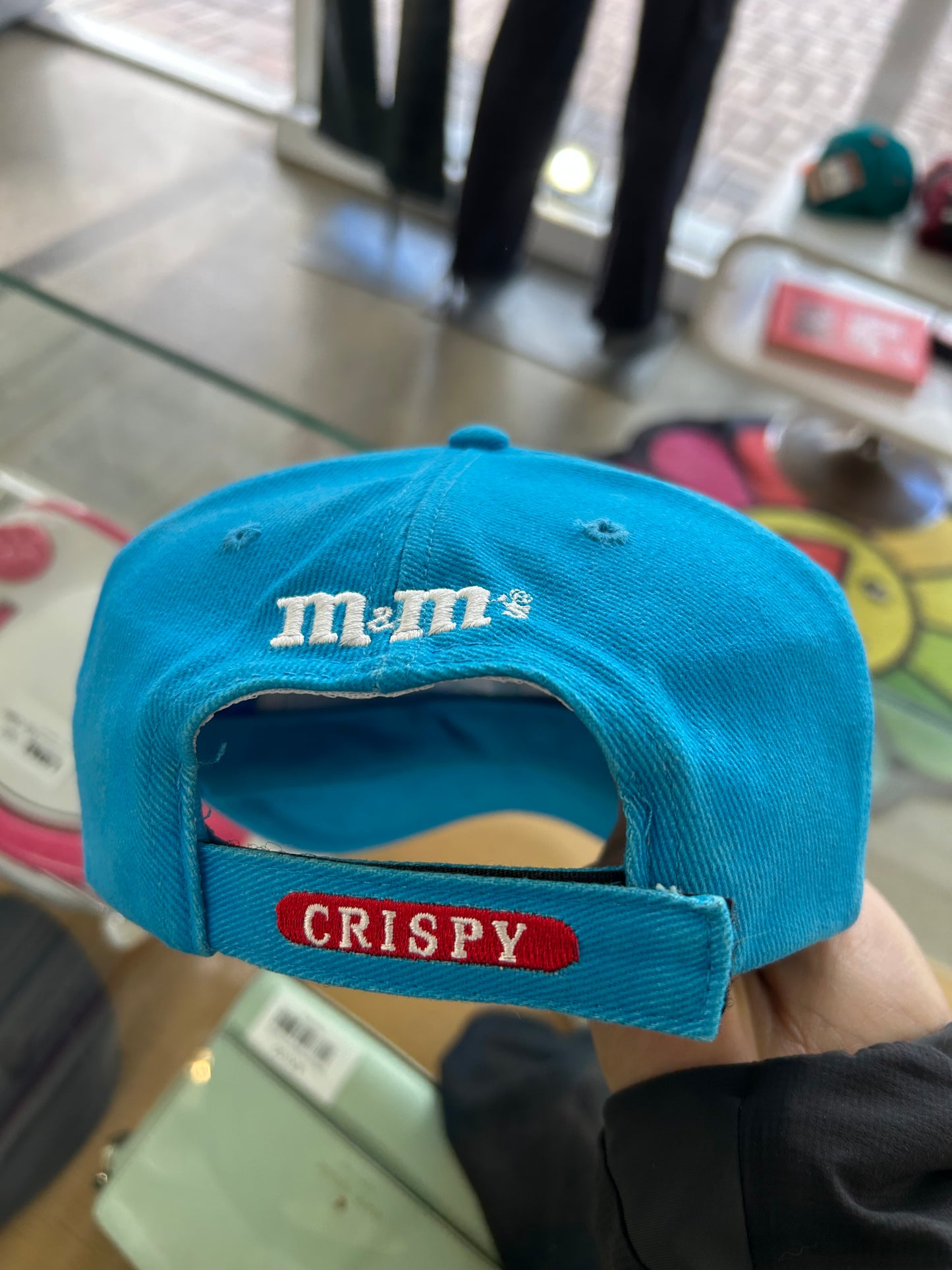 vintage 1999 M&M's Crispy "Orange" character advertising baseball cap in a vibrant turquoise blue.