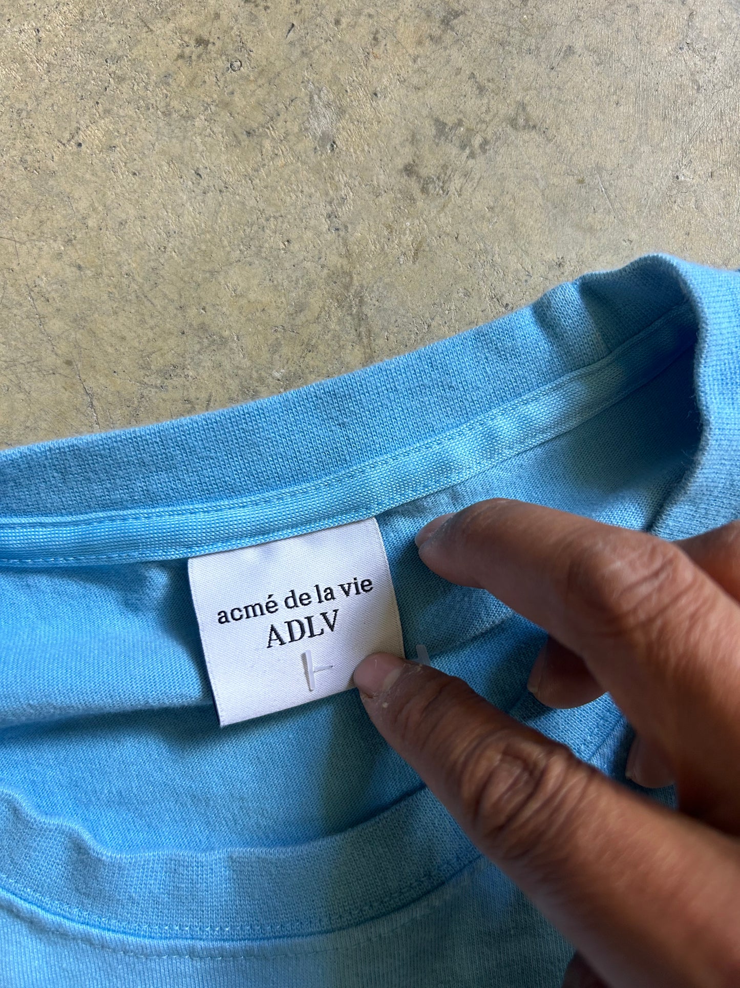 Acmé de la vie (ADLV) Glossy Basic Logo Short Sleeve T-Shirt in blue. Large