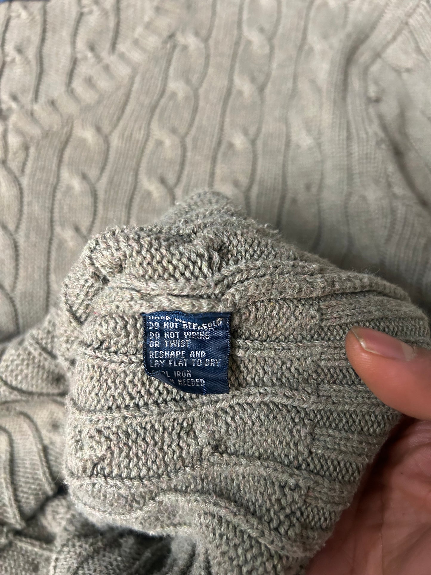 Vintage  Polo Ralph Lauren cable-knit V-neck sweater features a classic olive green textured weave and an embroidered signature pony logo
