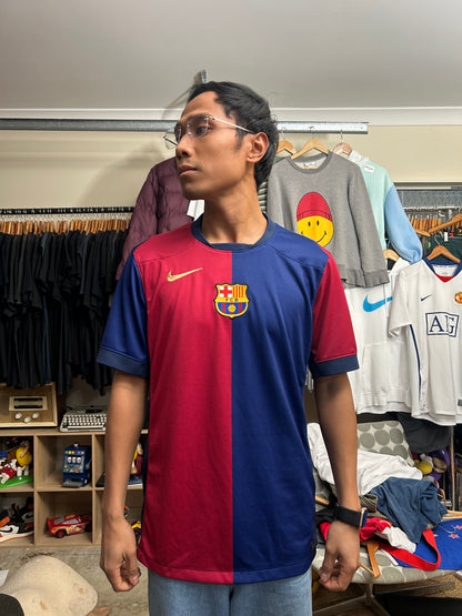 Nike FC Barcelona 2024/25 Home Jersey features a distinct split red and blue design with a gold Nike Swoosh