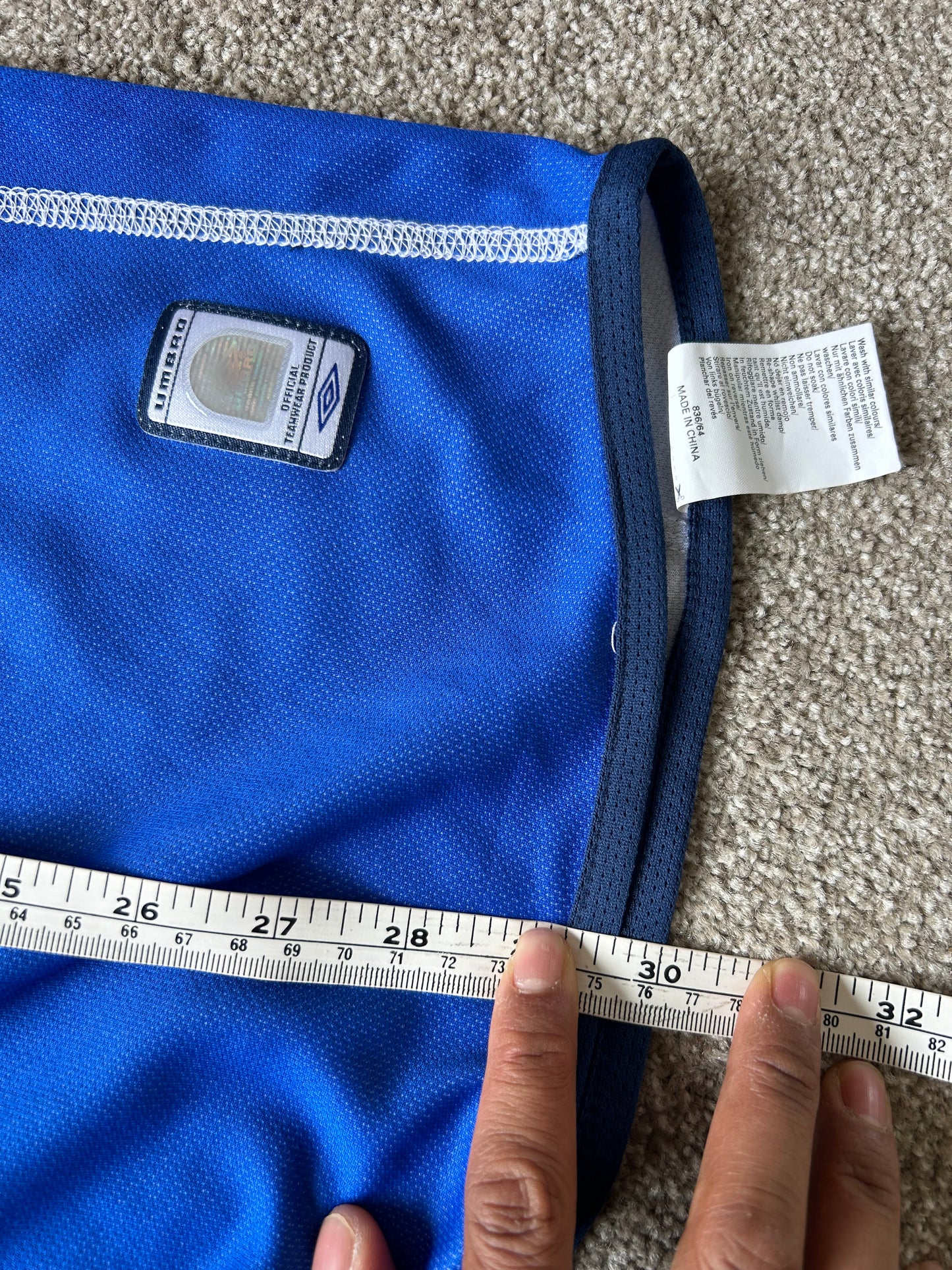 vibrant blue Umbro performance jersey featuring a V-neck design and white piping details XL