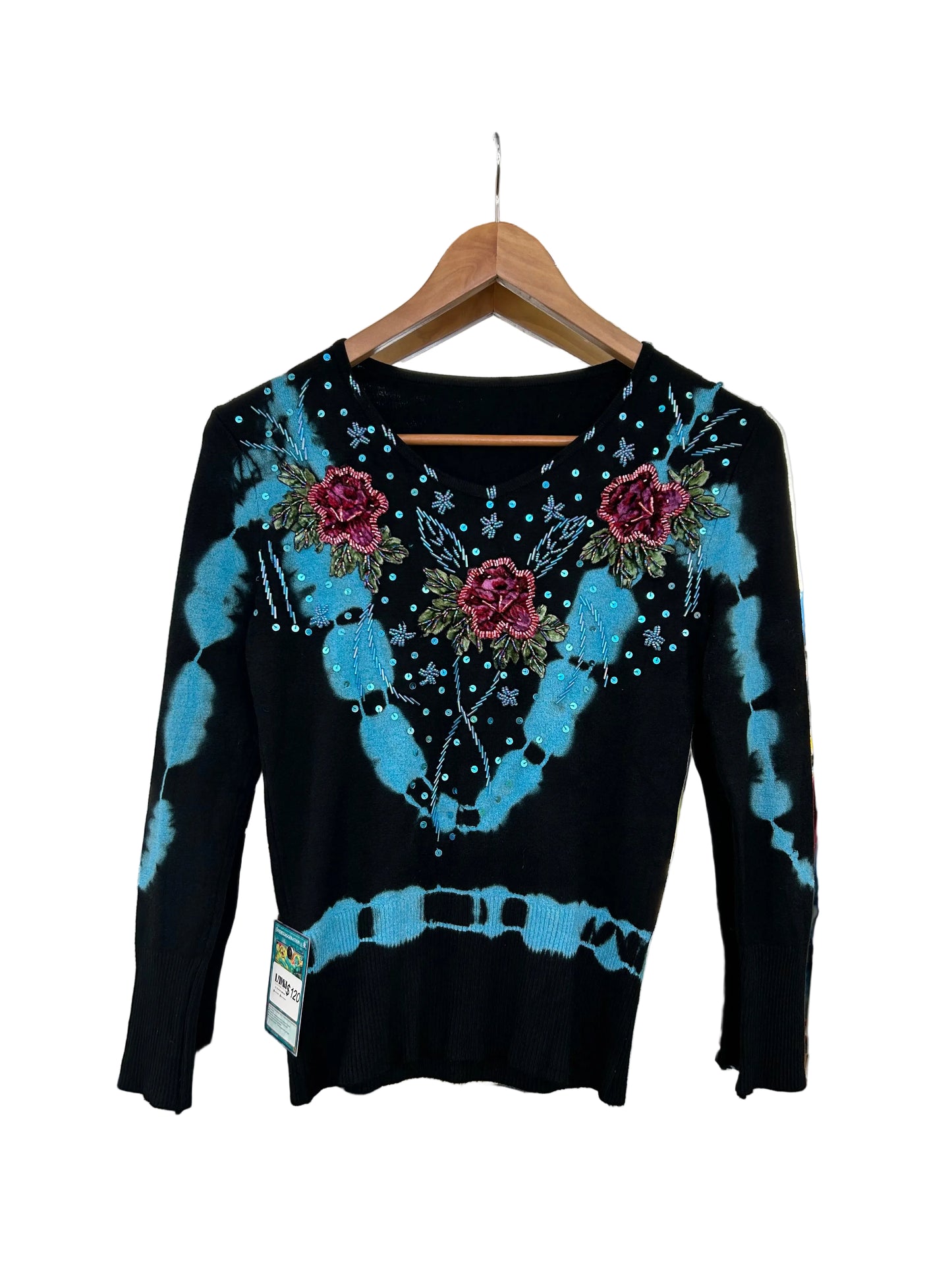 black knit sweater features blue tie-dye accents and floral embroidery with beaded details.