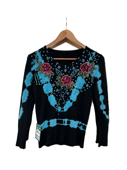 black knit sweater features blue tie-dye accents and floral embroidery with beaded details.