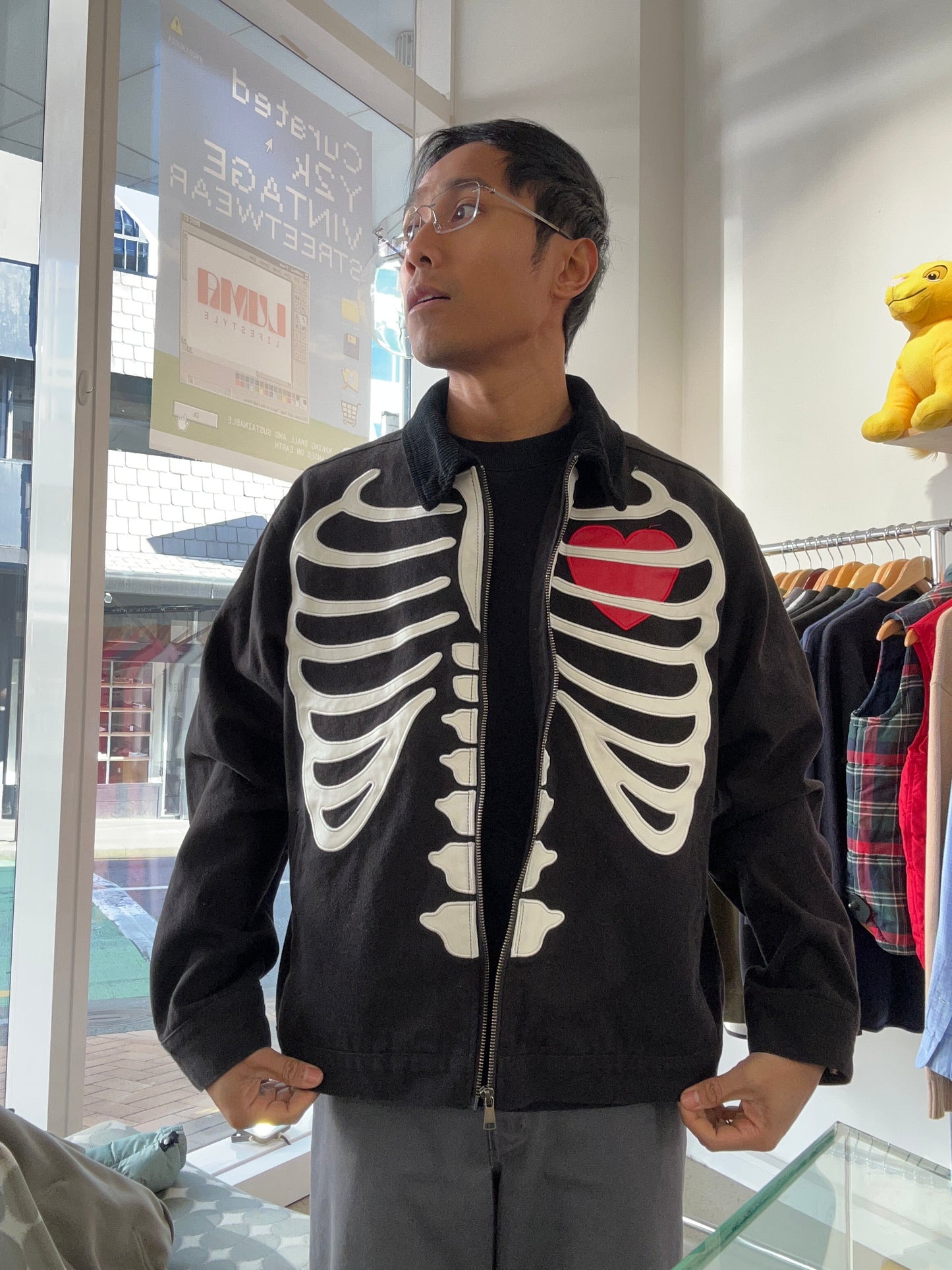 Loiter skeleton zip-up jacket in black, featuring a prominent ribcage graphic and a red heart detail Medium