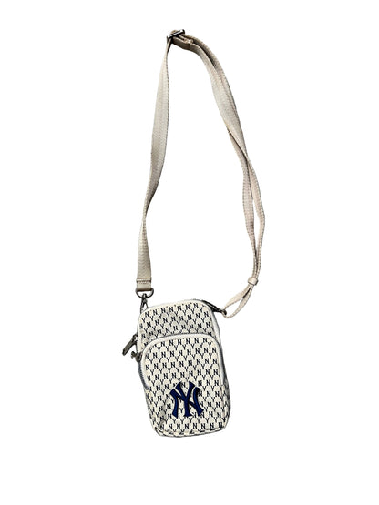 MLB New York Yankees mini bag features a repeating "NY" monogram pattern in ivory and blue