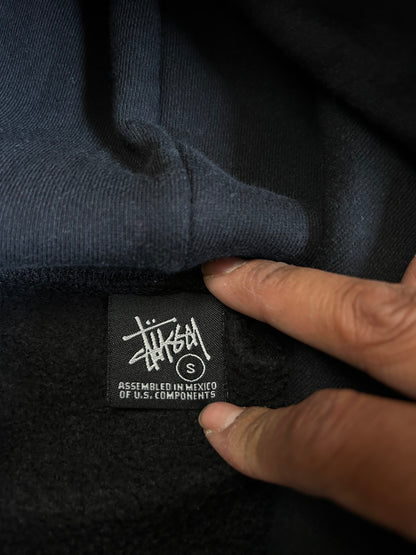 black, pullover-style hoodie featuring an all-over, multi-colored Stüssy logo print Small