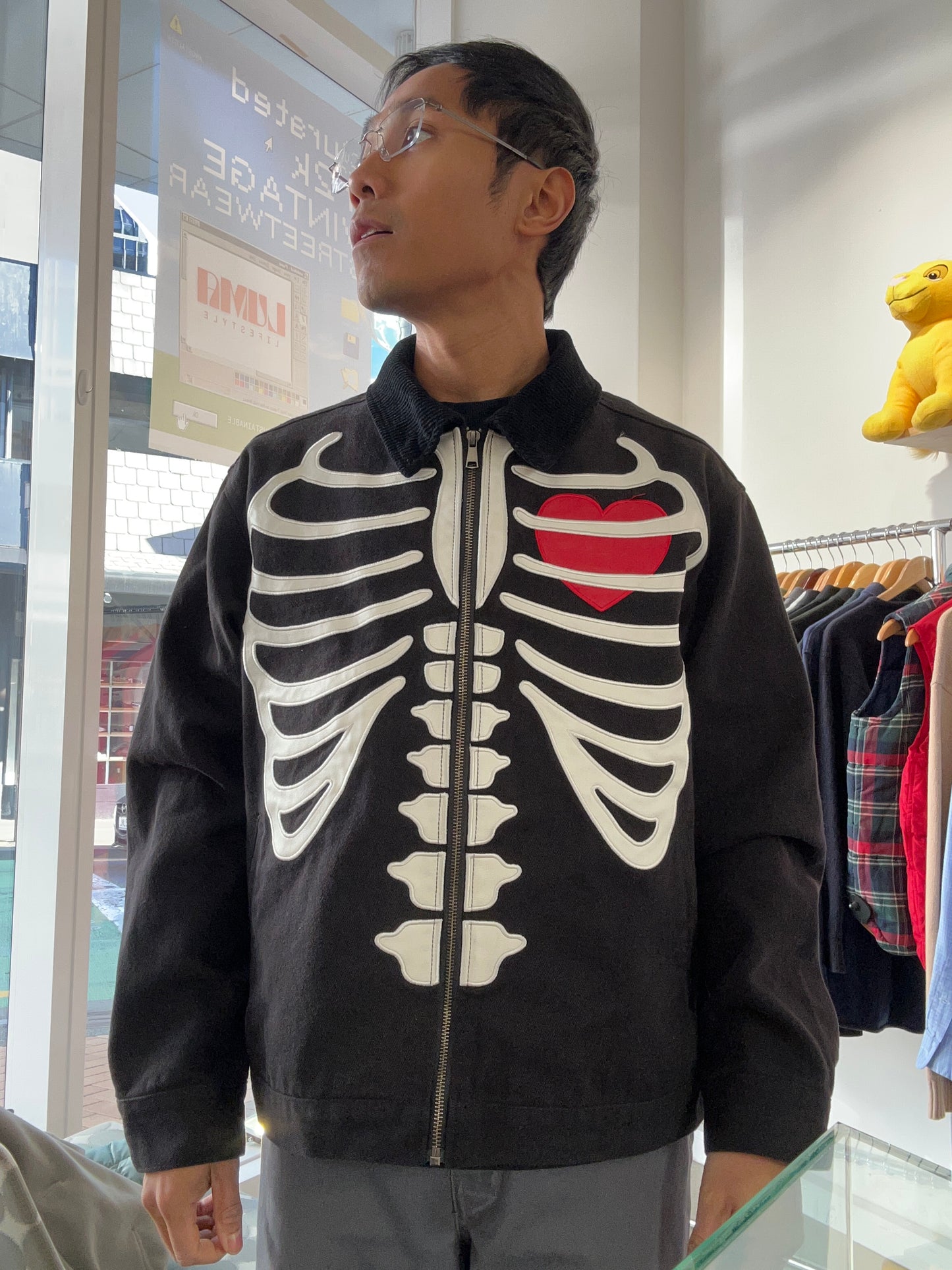 Loiter skeleton zip-up jacket in black, featuring a prominent ribcage graphic and a red heart detail Medium
