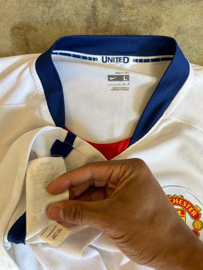 Nike Manchester United away jersey from the 2008-2009 season, featuring a classic white design with a blue V-neck and "AIG Large White
