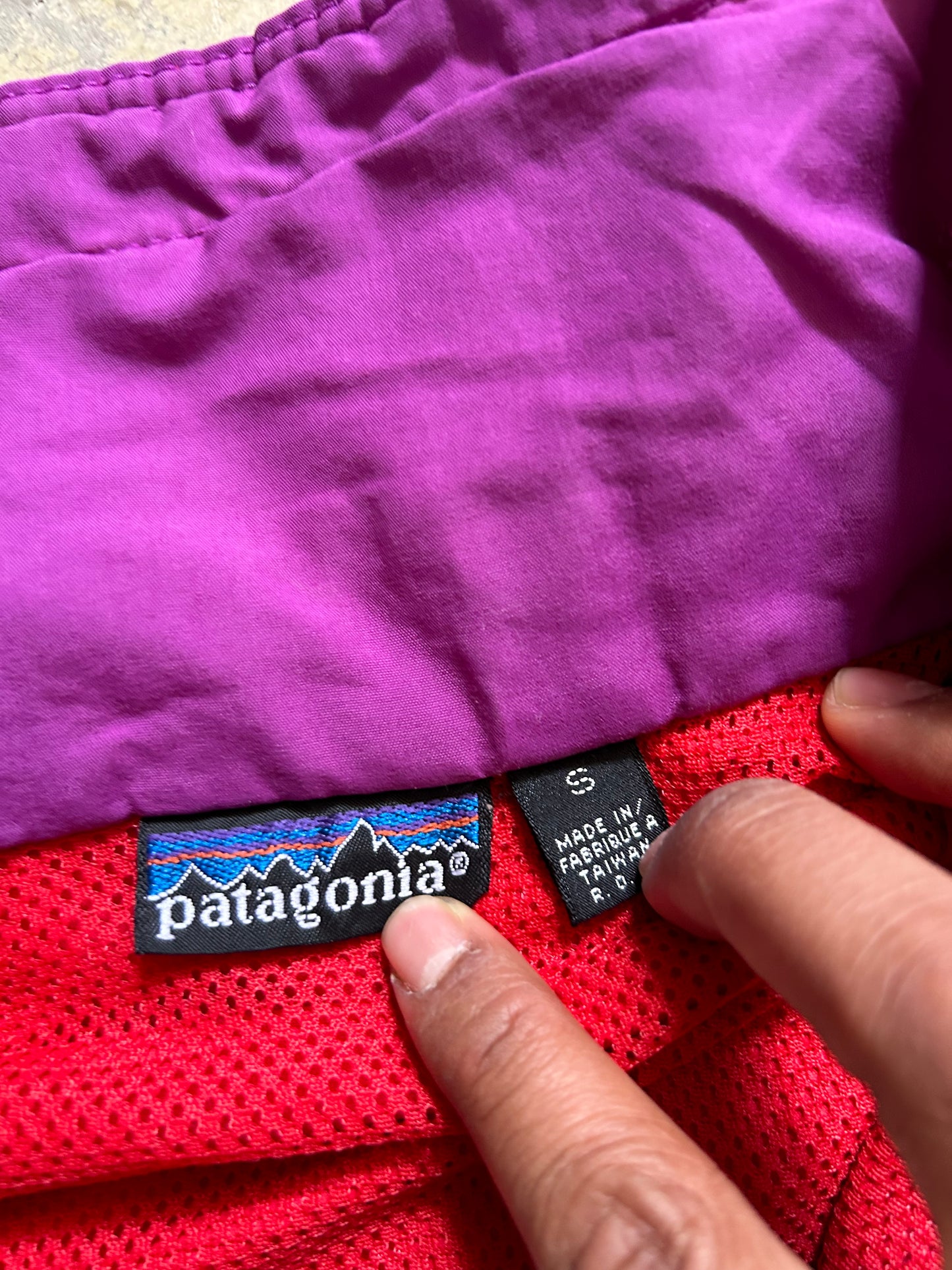 vintage Patagonia jacket, likely from the Fall Line collection, featuring a vibrant red shell and a purple collar Medium
