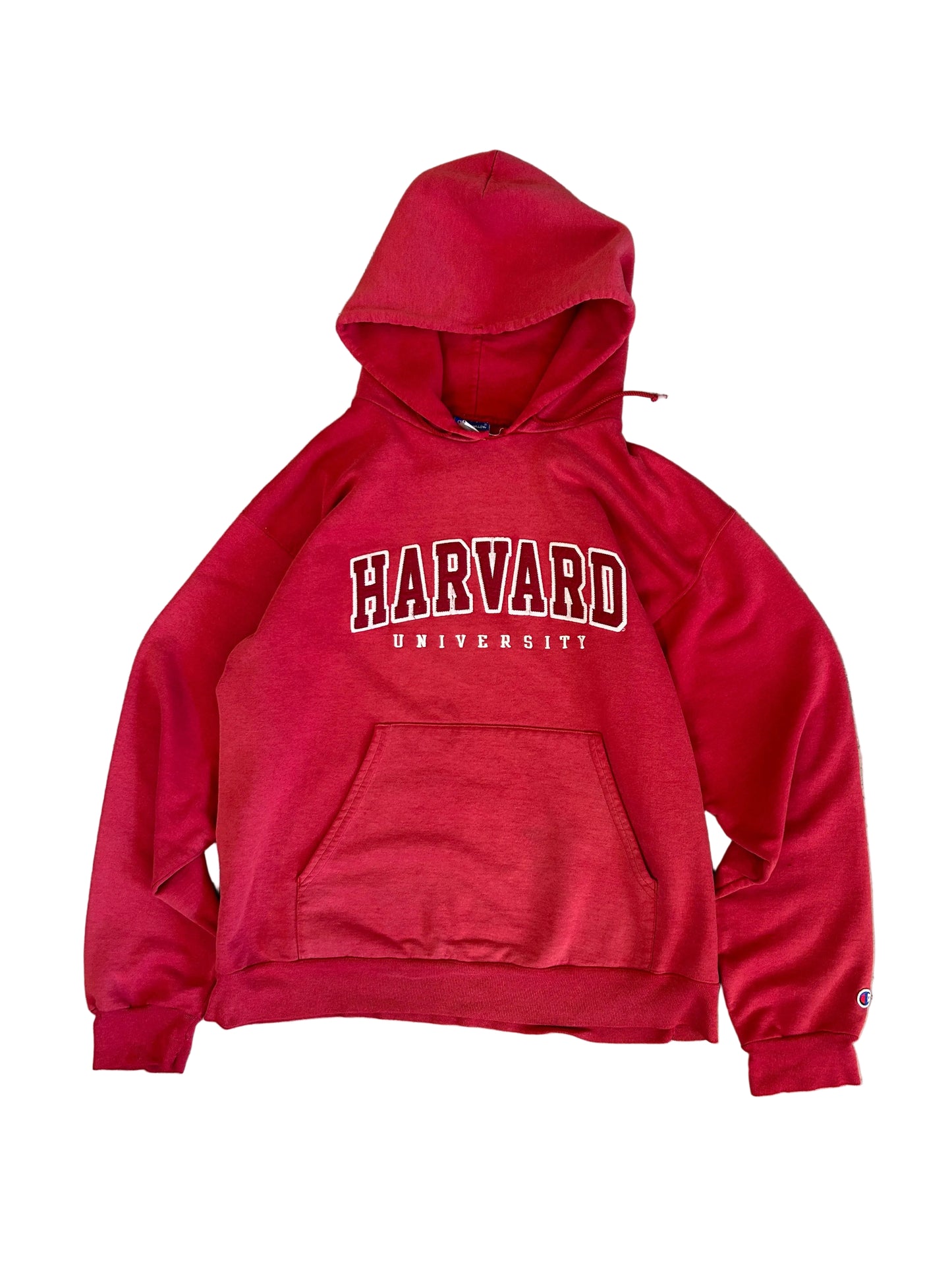 Vintage Fade red Champion hoodie features a prominent arched "HARVARD" spellout graphic and a comfortable kangaroo pocket Large