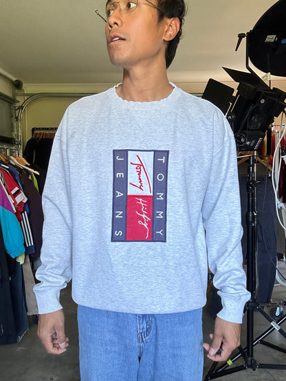 vintage-style Tommy Jeans crewneck sweatshirt features a prominent vertical logo patch on the chest Large