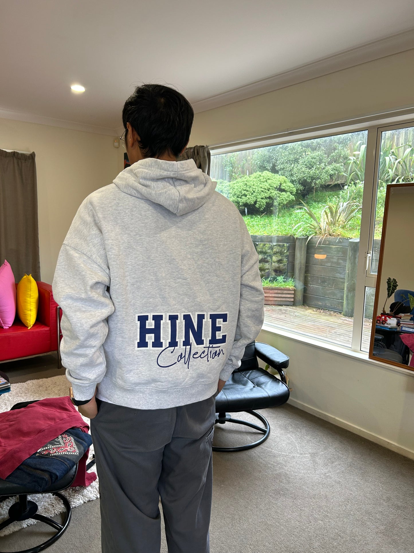 Hine Collection gray hoodie features a prominent navy blue "HC" embroidered logo on the chest
