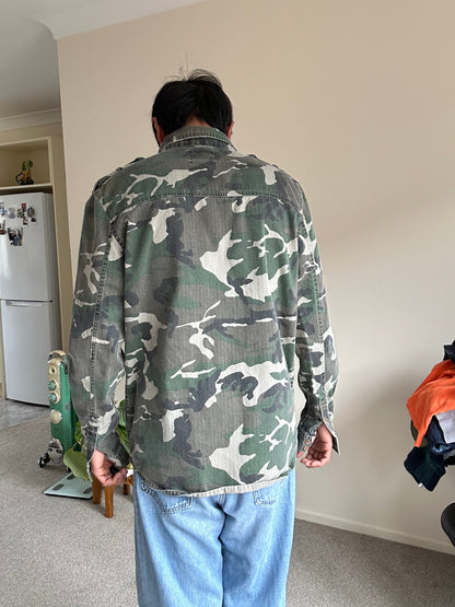 Stussy camouflage cargo shirt featuring a button-up front and a logo patch on the chest Medium
