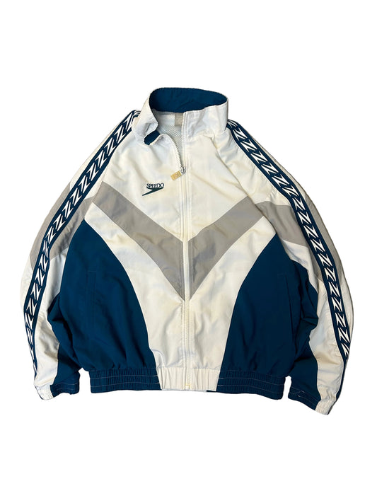 vintage Speedo windbreaker jacket featuring a white, blue, and gray color-block design with signature zigzag patterned Large White