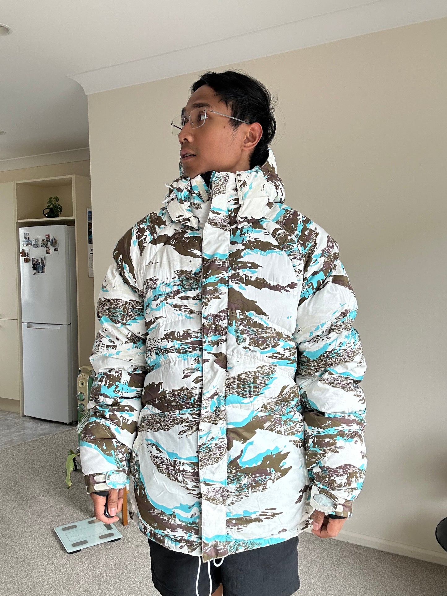 Oakley Avalanche NVL4 snow jacket in a white, brown, and blue camouflage pattern Large
