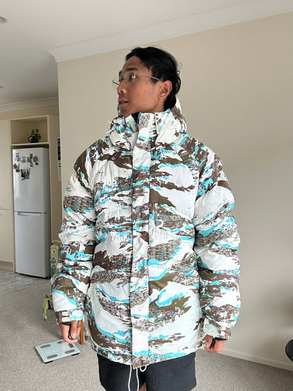 Oakley Avalanche NVL4 snow jacket in a white, brown, and blue camouflage pattern Large