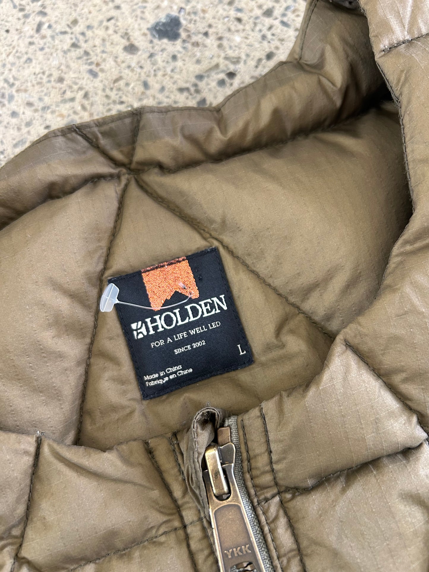 Holden Pyramid Down Vest in a brown olive color, featuring a unique triangular quilted pattern. Large