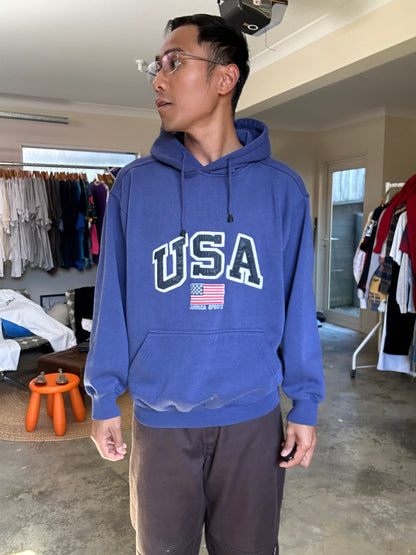 vintage navy blue hoodie features a prominent embroidered "USA" logo and an American flag graphic, Large