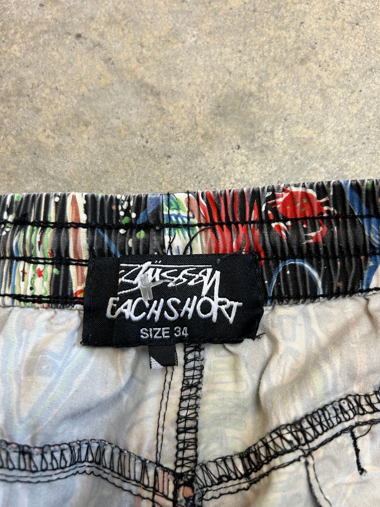 Stüssy beach shorts featuring an all-over fishing-themed graphic print size 34