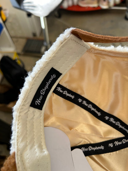 New Shepherds Sherpa Baseball Cap featuring a white fleece crown, a brown brim, and a gold embroidered 'B