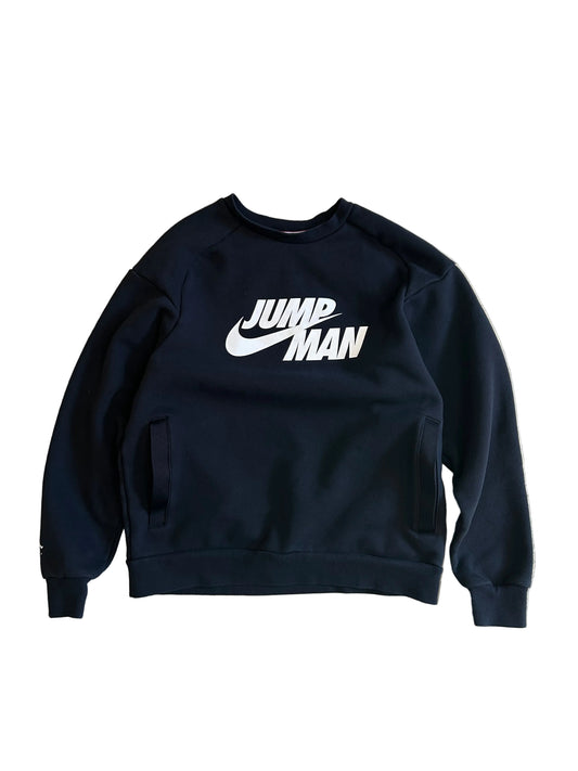 black Jordan Jumpman Men's Fleece Crew Sweatshirt, which features side pockets and a prominent white "JUMPMAN" graphic with the Nike swoosh Medium