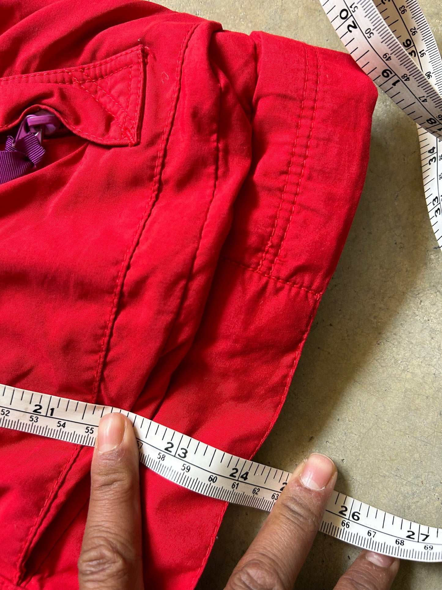vintage Patagonia jacket, likely from the Fall Line collection, featuring a vibrant red shell and a purple collar Medium