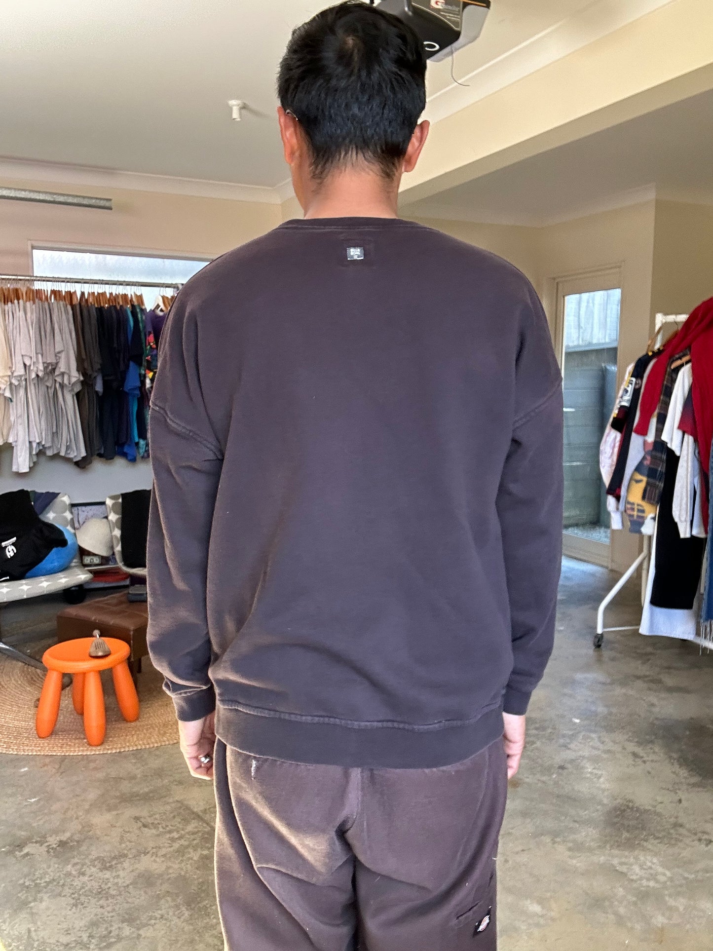Faded black sweatshirt is a Billabong crewneck featuring a yellow palm tree logo on the chest Large