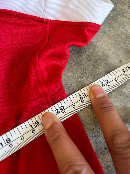 Nike Liverpool FC 2023/24 Home Jersey, featuring a classic red design with prominent white collar and sleeve cuffs. Medium