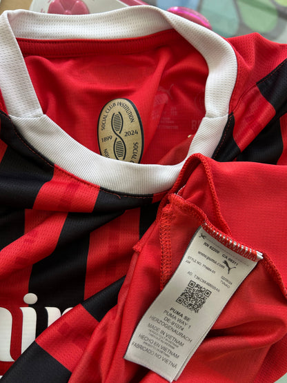 red and black striped Puma AC Milan 2024/25 home jersey featuring the white "Emirates Fly Better" sponsor logo XS