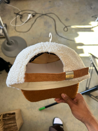 New Shepherds Sherpa Baseball Cap featuring a white fleece crown, a brown brim, and a gold embroidered 'B