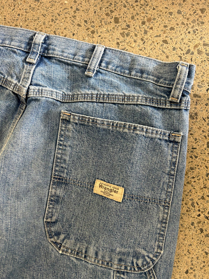 Wrangler carpenter pants feature a classic hammer loop and utility pockets on the side size 34 Blue