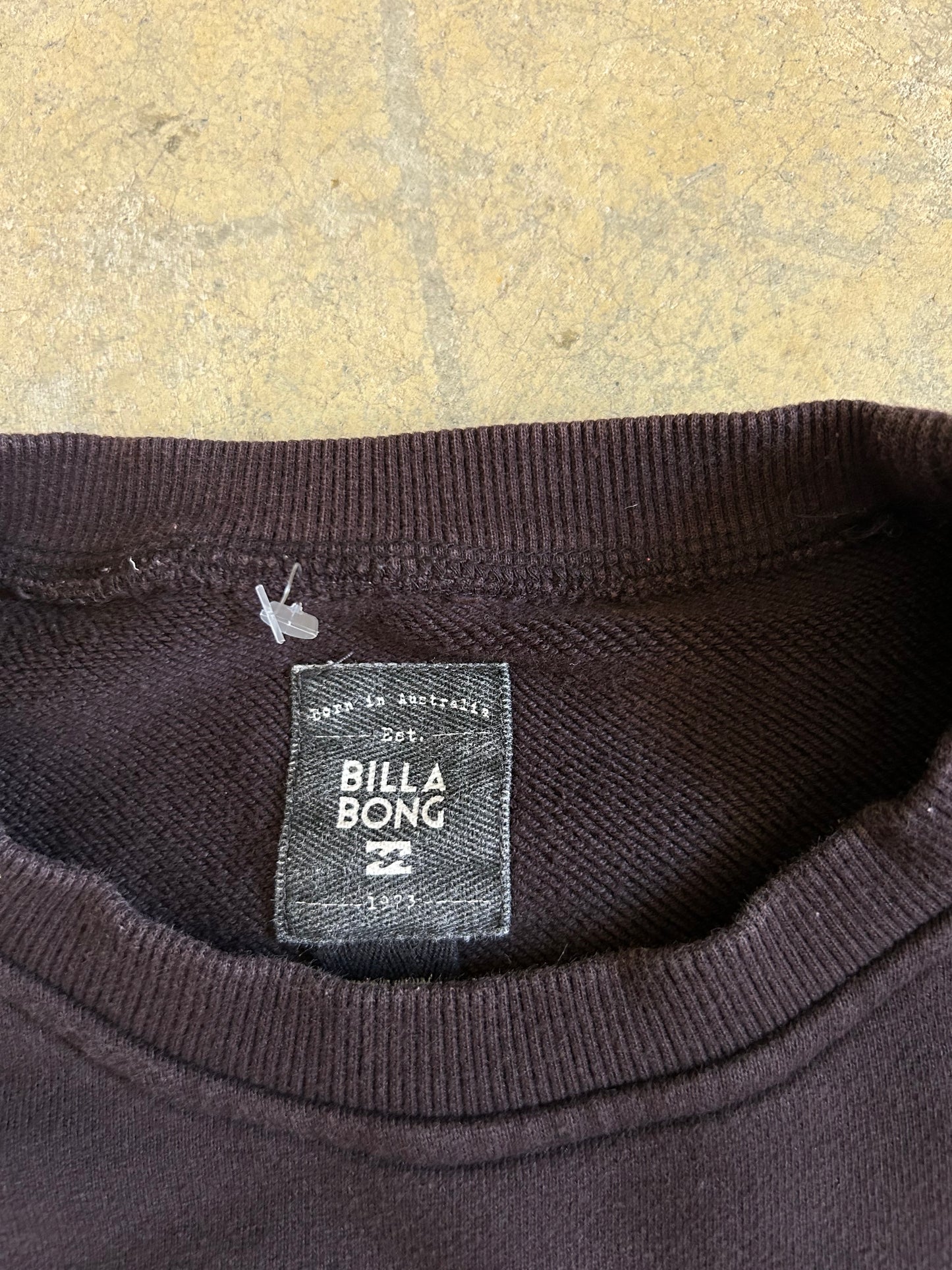 Faded black sweatshirt is a Billabong crewneck featuring a yellow palm tree logo on the chest Large