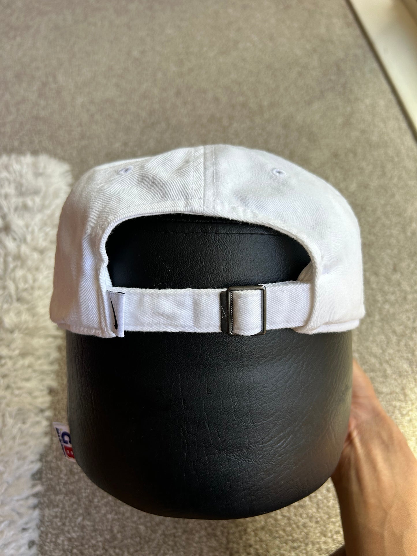 White Nike Club Cap with an outlined black Swoosh logo