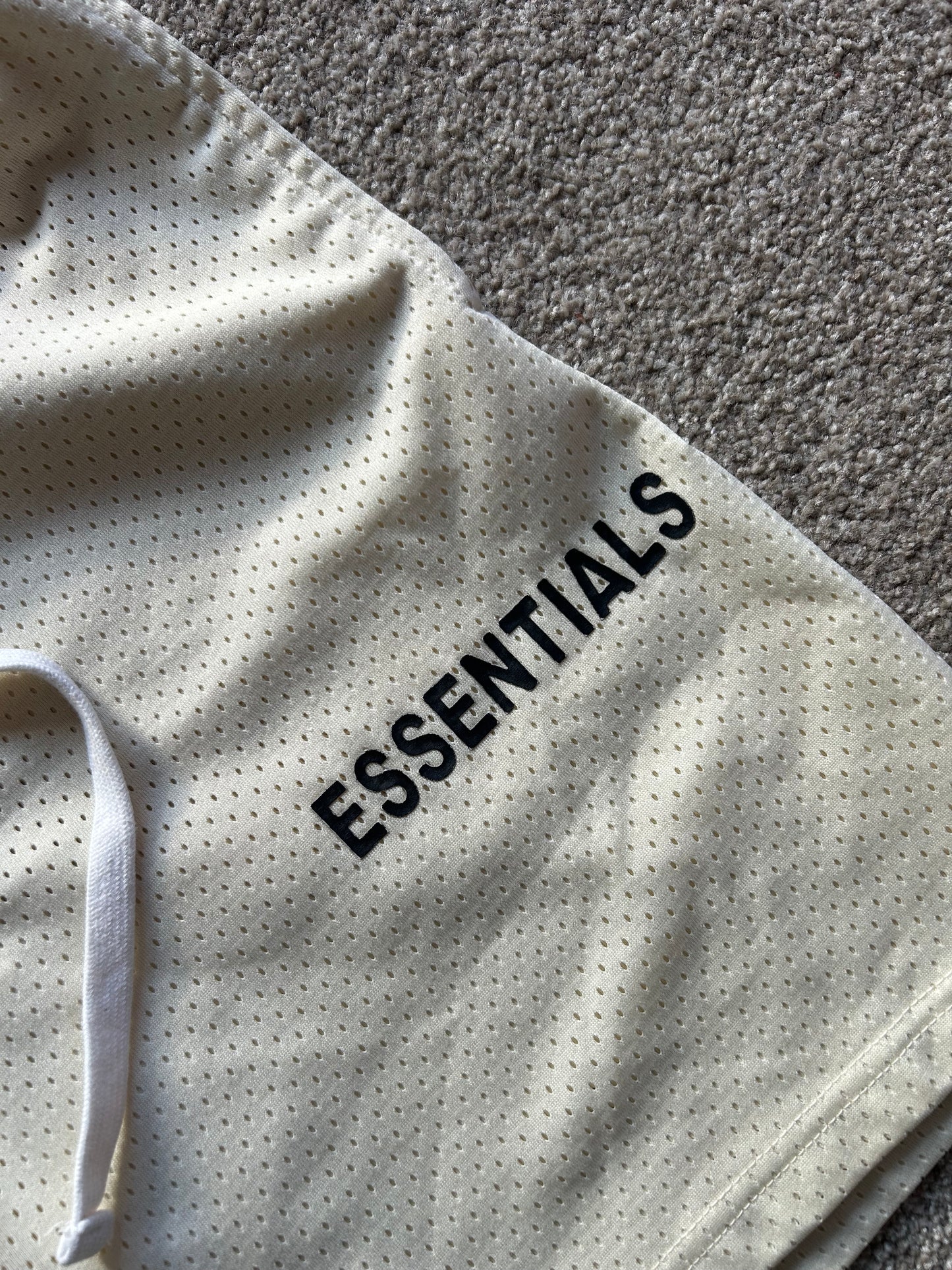 Fear of God Essentials Graphic Mesh Drawstring Shorts
Cream Medium