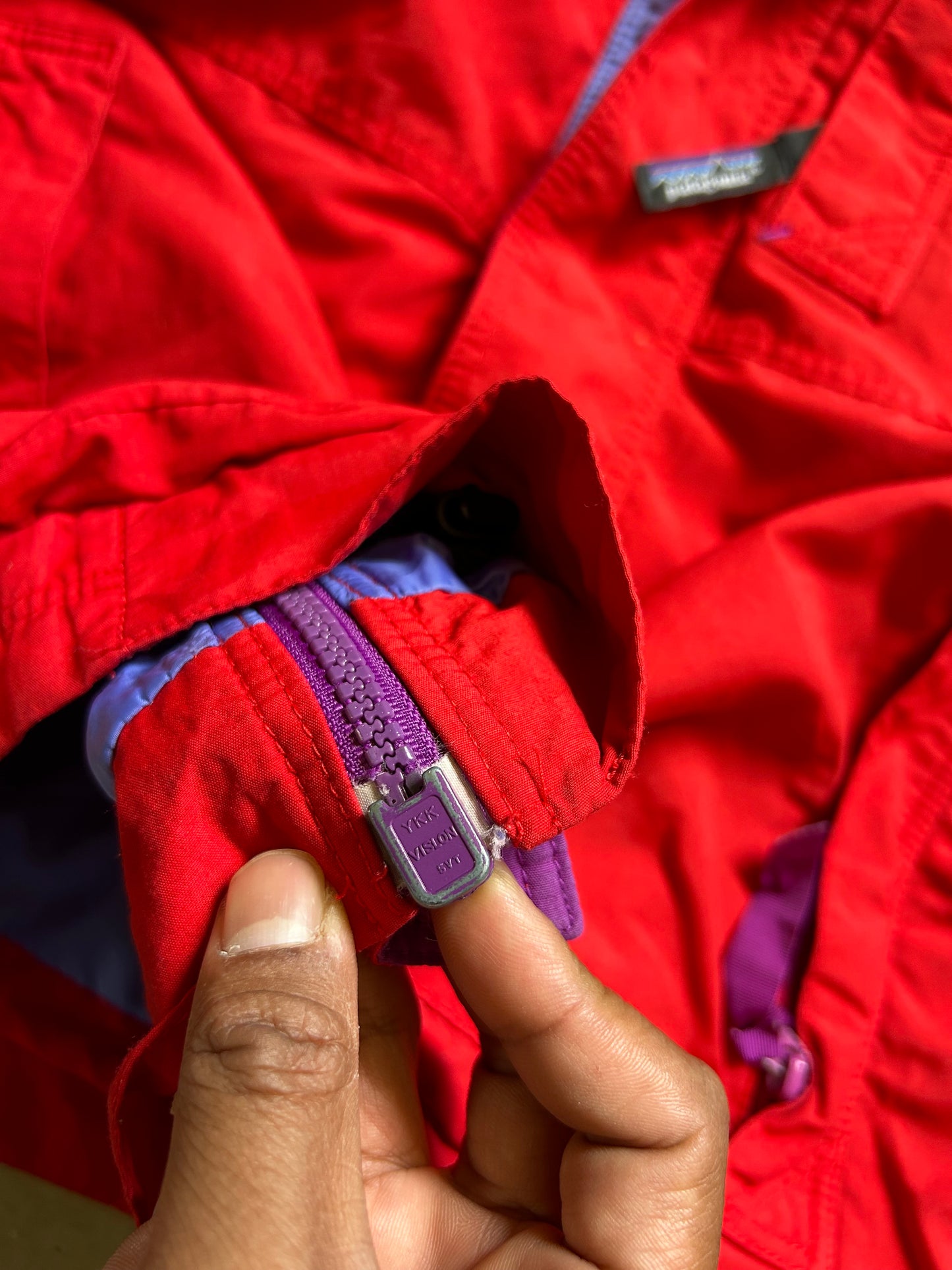 vintage Patagonia jacket, likely from the Fall Line collection, featuring a vibrant red shell and a purple collar Medium