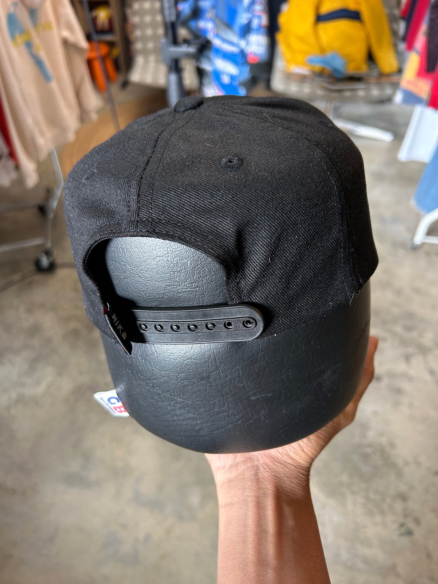 Vintage black Nike baseball cap featuring a white embroidered Swoosh Cotton