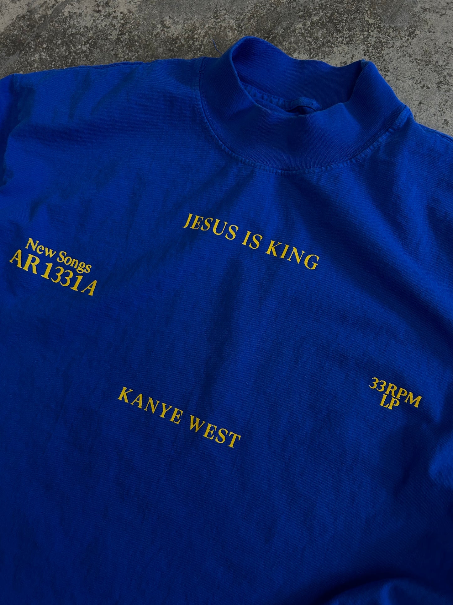 royal blue Kanye West "Jesus Is King" vinyl merchandise t-shirt featuring yellow puff print text Medium