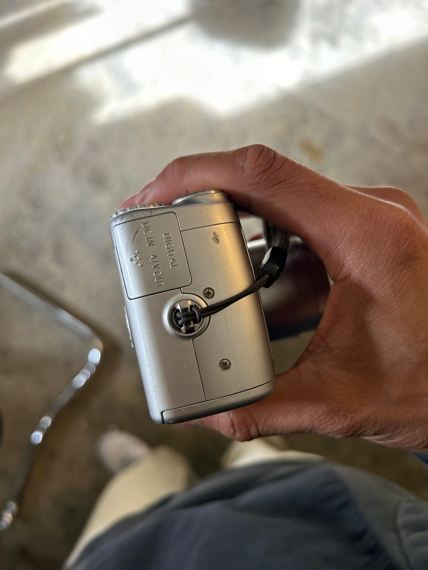silver Canon PowerShot SX100 IS digital camera with a 10x optical zoom lens