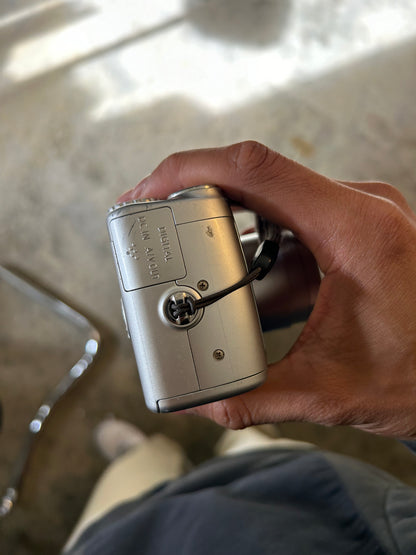 silver Canon PowerShot SX100 IS digital camera with a 10x optical zoom lens