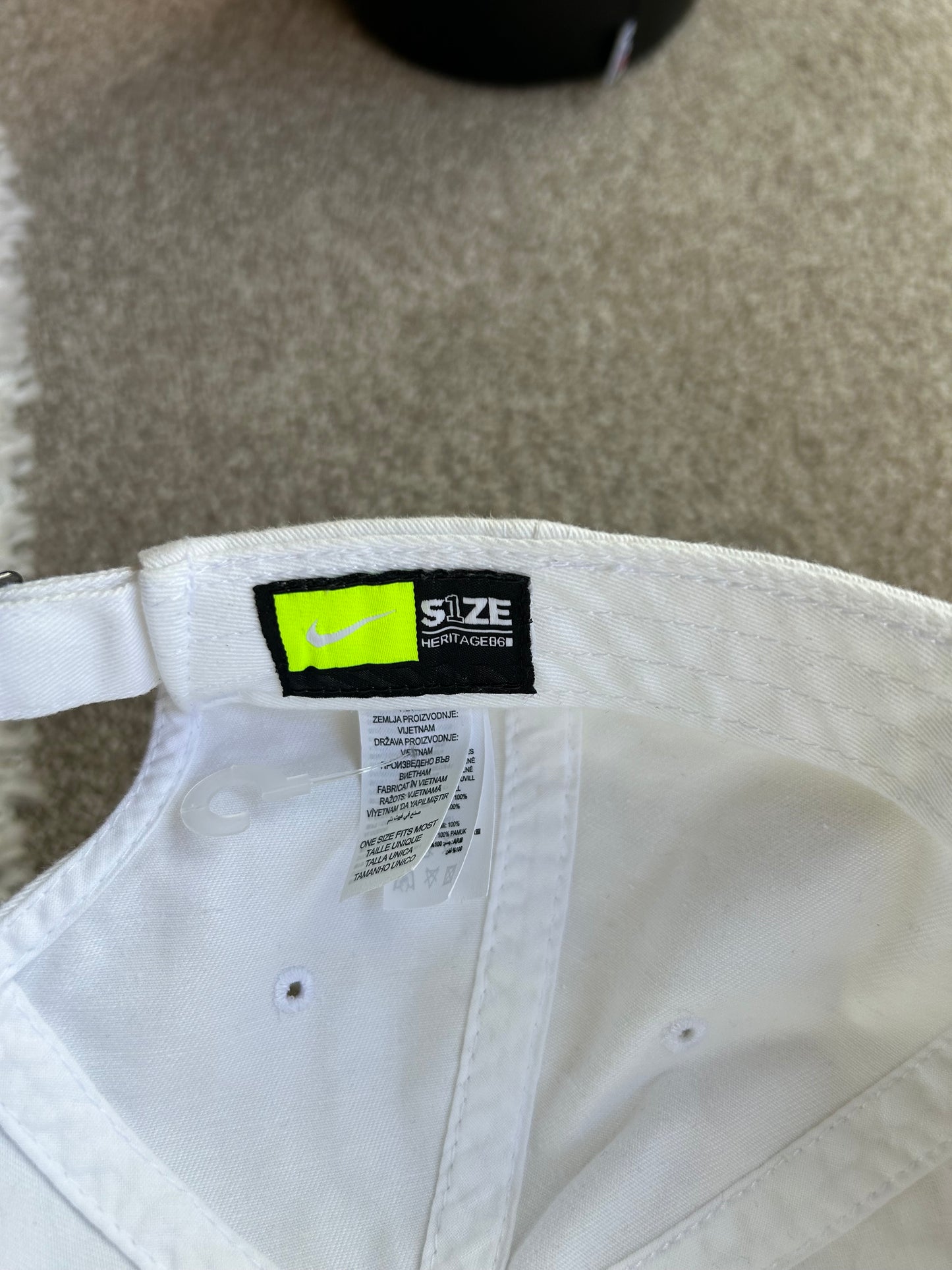 White Nike Club Cap with an outlined black Swoosh logo